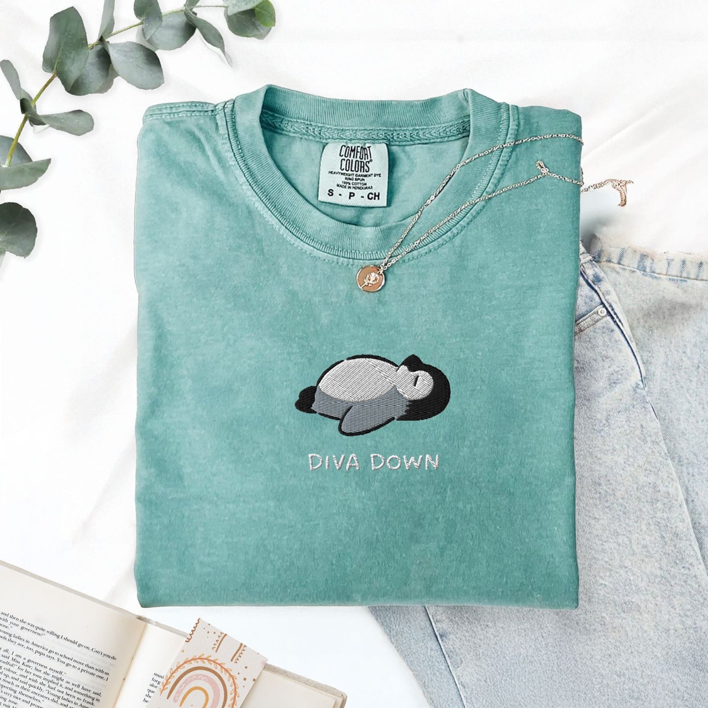 Pine Spice Books Diva Down Penguin Embroidered T-Shirt Diva Down Penguin Embroidered T-Shirt