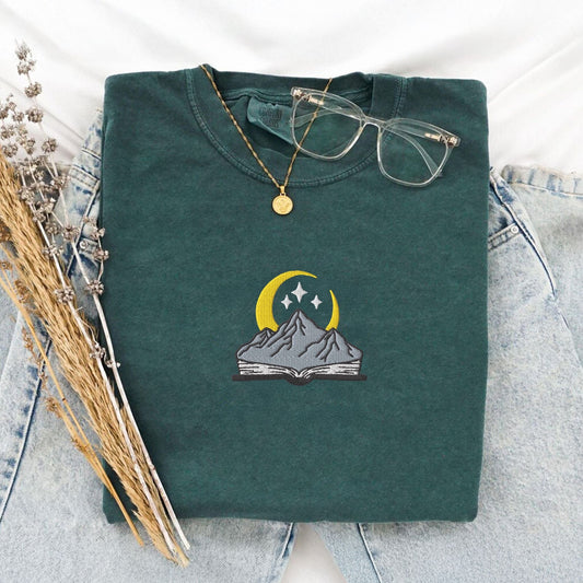 My Store Embroidered open book with mountain and stars, comfort colors embroidered fantasy book tee, ACOTAR merch Fourth Wing Romantasy bookish gift Embroidered open book with mountain and stars, comfort colors embroidered fantasy book tee, ACOTAR merch Fourth Wing Romantasy bookish gift
