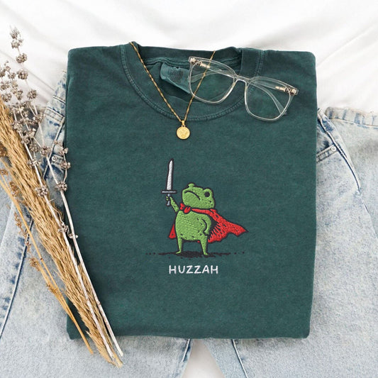Pine Spice Books Huzzah Frog Embroidered T-Shirt – Comfort Colors 1717 Huzzah Frog Embroidered T-Shirt – Comfort Colors 1717