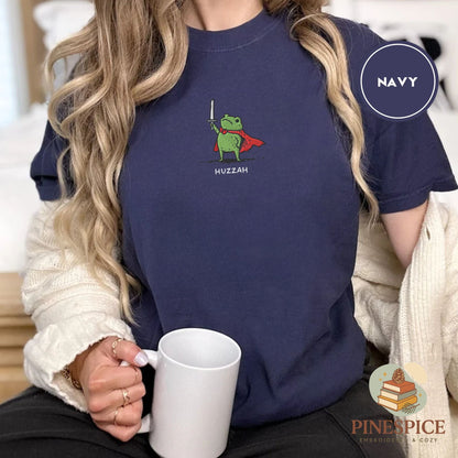 Pine Spice Books Huzzah Frog Embroidered T-Shirt – Comfort Colors 1717 Huzzah Frog Embroidered T-Shirt – Comfort Colors 1717