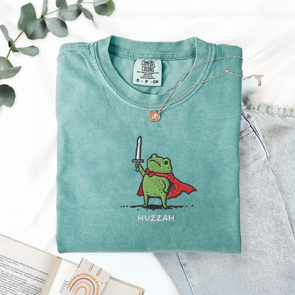 Pine Spice Books Huzzah Frog Embroidered T-Shirt – Comfort Colors 1717 Huzzah Frog Embroidered T-Shirt – Comfort Colors 1717
